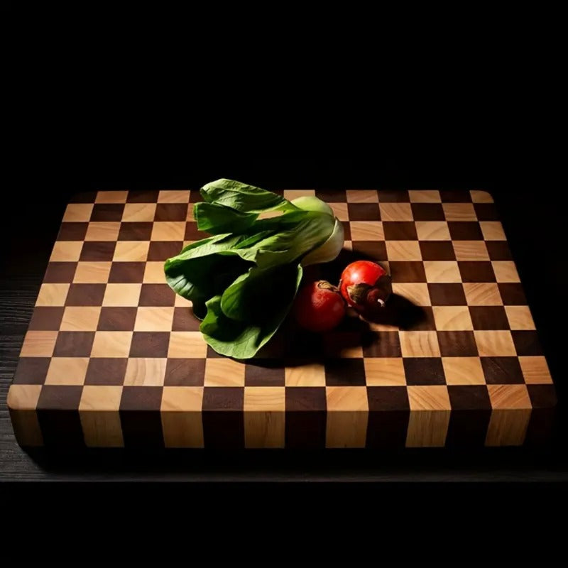 Checkered wooden cutting board with a head of lettuce and two tomatoes on a dark background