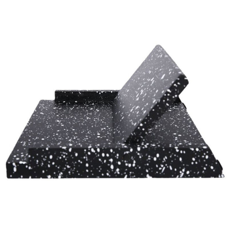 Black and white speckled foam roller on a white background