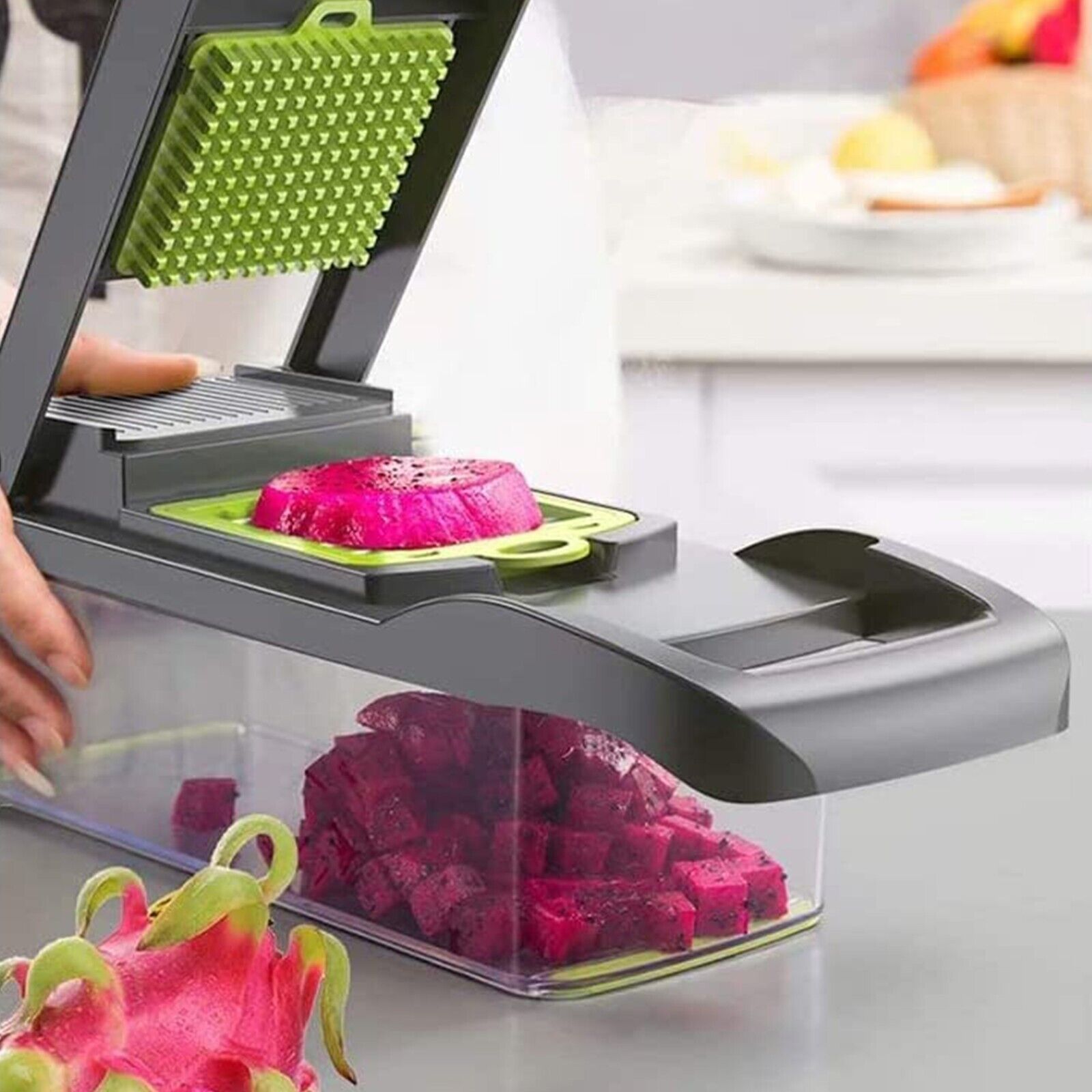 Dragon fruit being sliced with a kitchen slicer on a countertop.