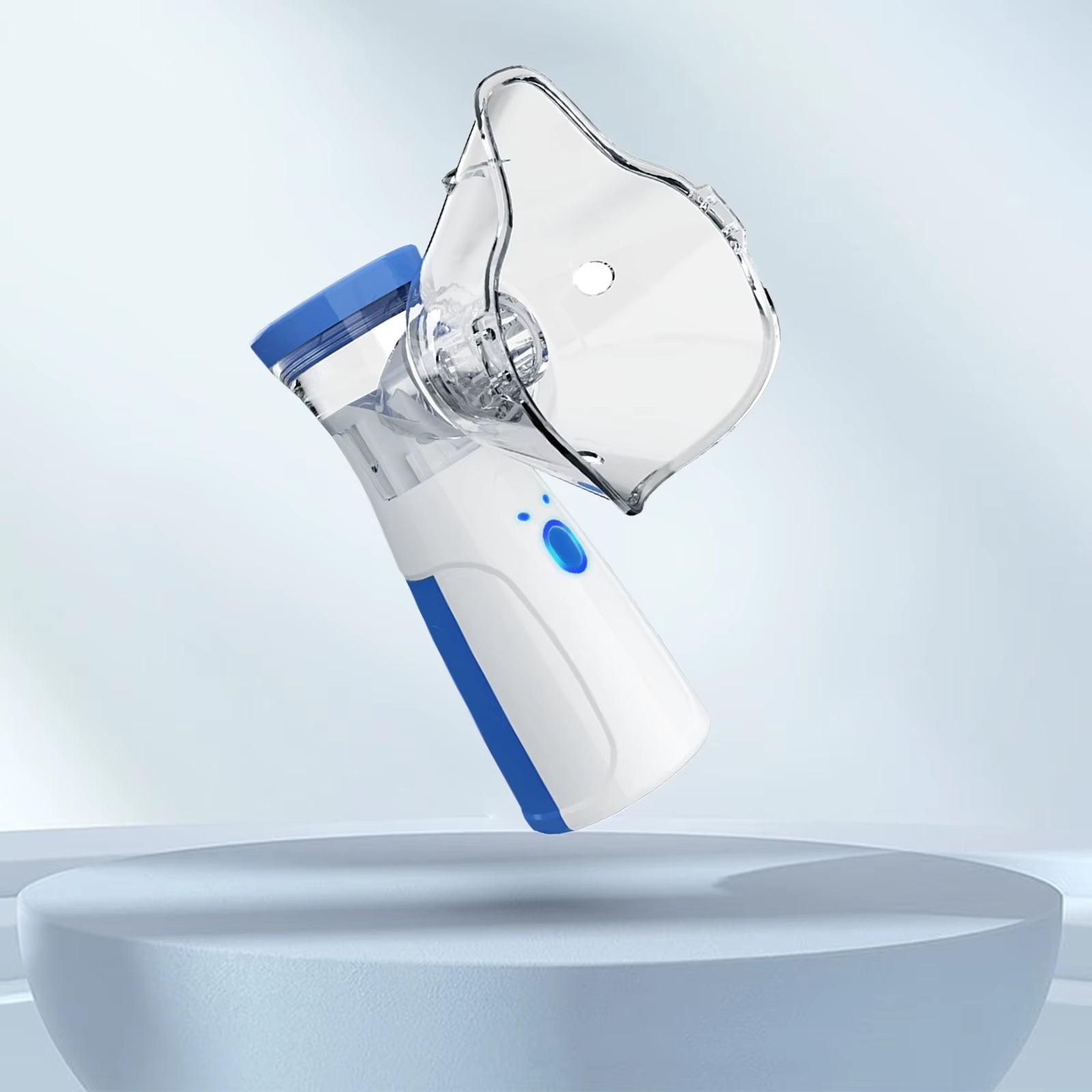 Clear and blue雾化器 on a light gray background