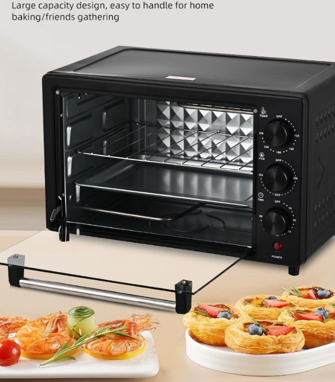 Black toaster oven with a large capacity design, shown with baked goods on a table.