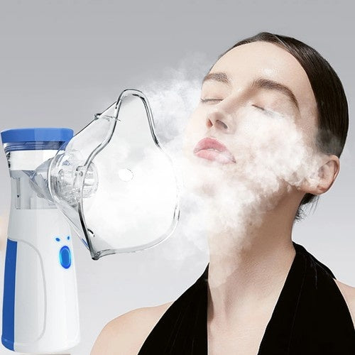 Person using a nebulizer with steam coming out, on a gray background