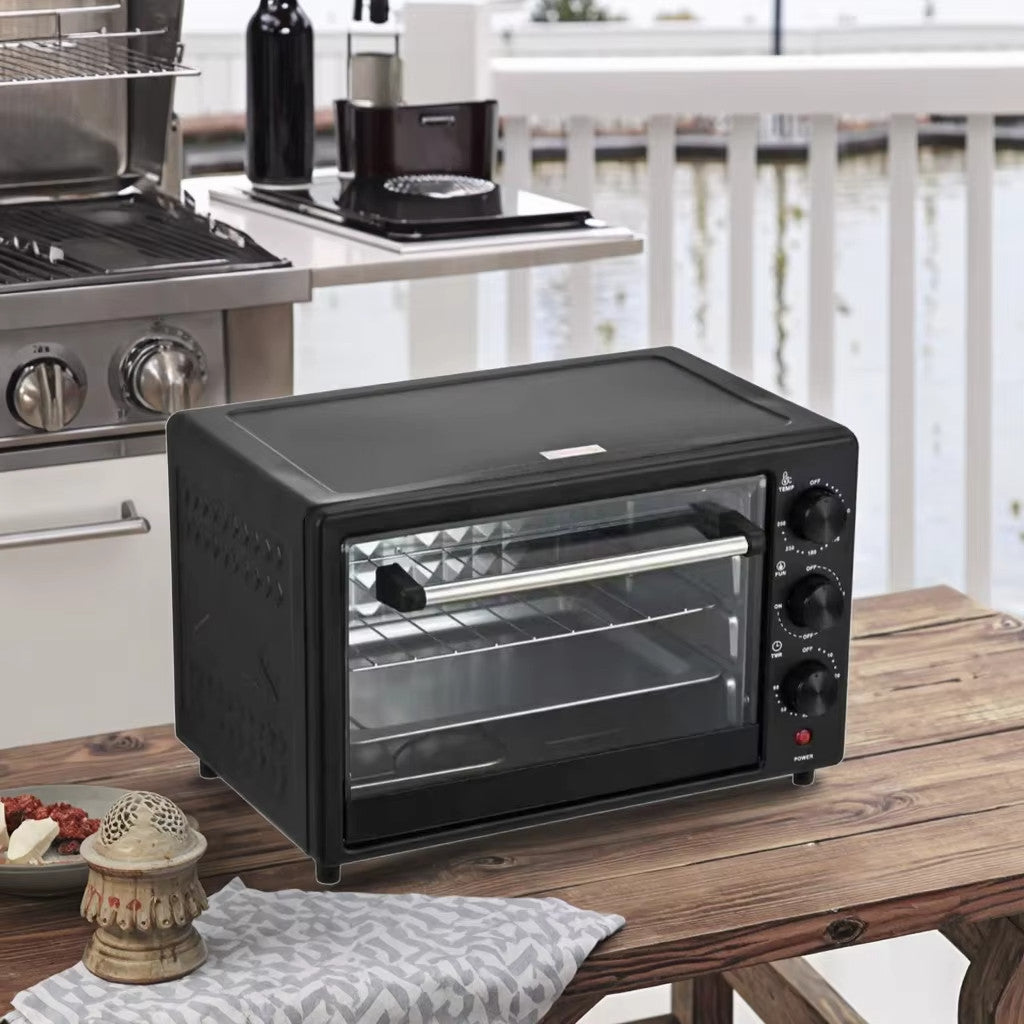 Black toaster oven on a wooden table in a kitchen setting