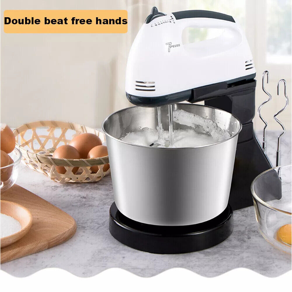 Stand mixer with a bowl on a kitchen counter, surrounded by eggs and kitchen utensils.