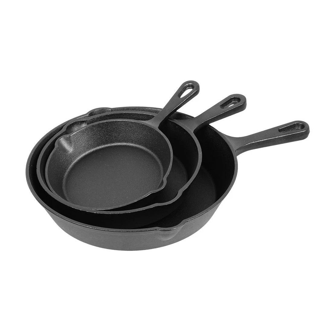 Set of three black cast iron skillets on a white background