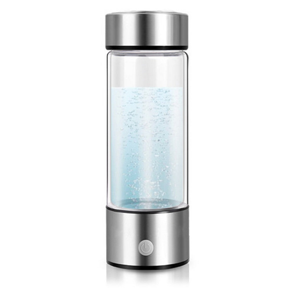 Clear glass bottle with silver top and base on a white background
