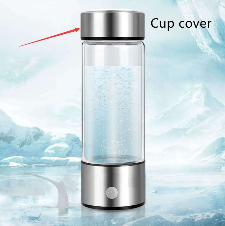 Glass water bottle with silver lid on a snowy background