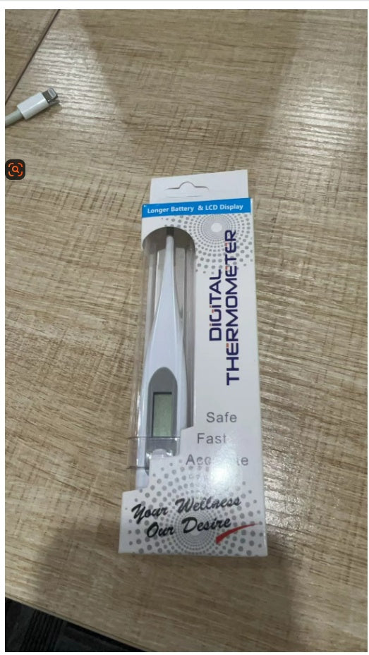 Digital thermometer packaging on a wooden surface