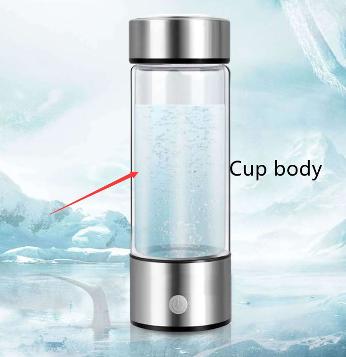 Clear glass cup with silver lid and base on a light blue background